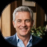 Portrait of a smiling middle-aged man with gray hair wearing dark blue blazer